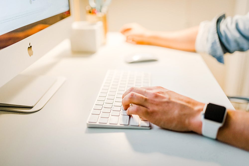 person working on a mac desktop