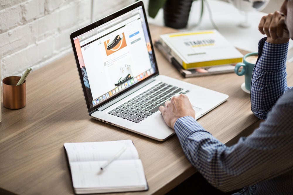 man-at-desk-working-on-laptop