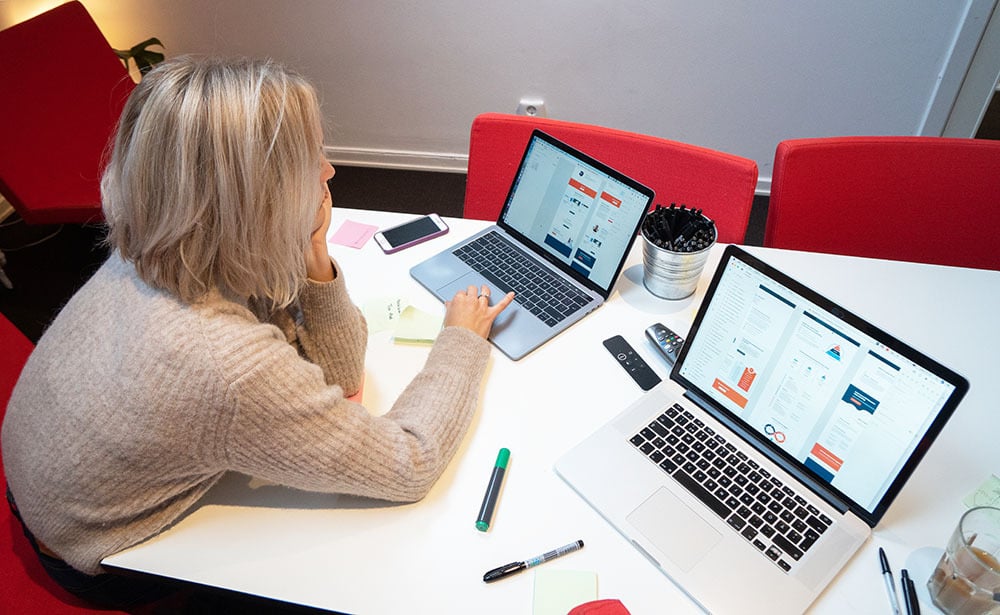 Marketer sitting at a table working on laptop